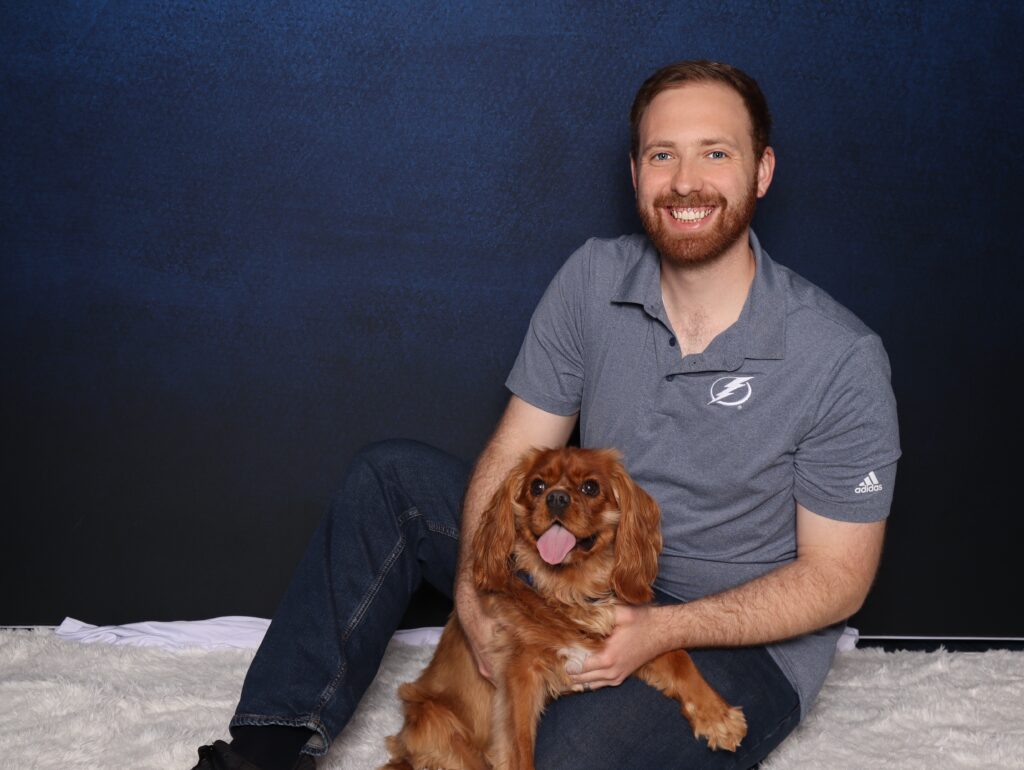 key chain Photo Booth station in Tampa Bay. man posing with dog in Photo Booth