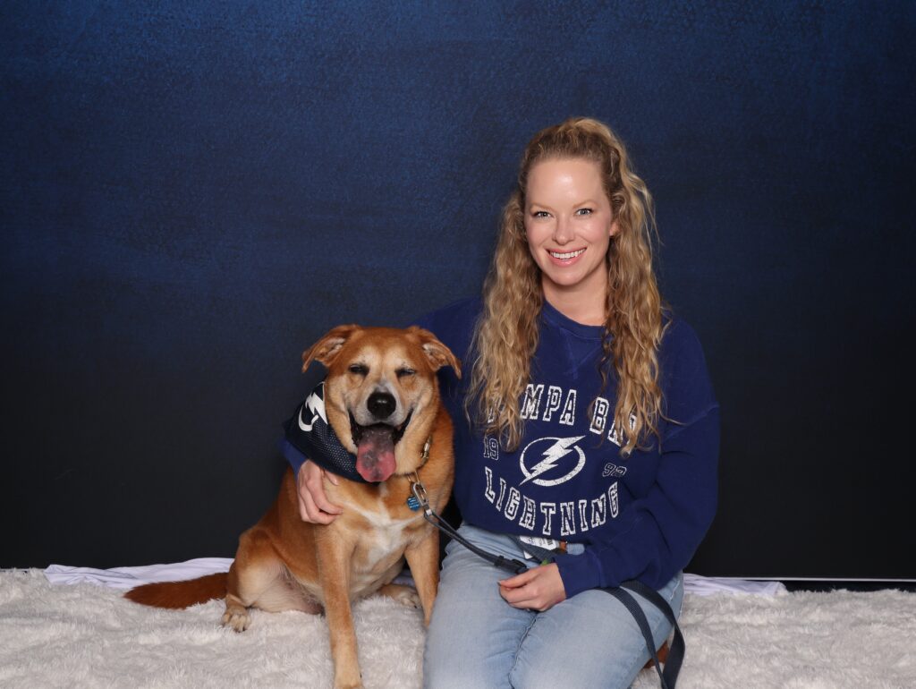 benchmark arena in tampa, fl employee posing with dog in photo booth