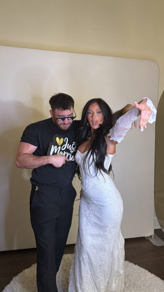 wedding bride and groom posing in photo booth at Bella cosa wedding venue
