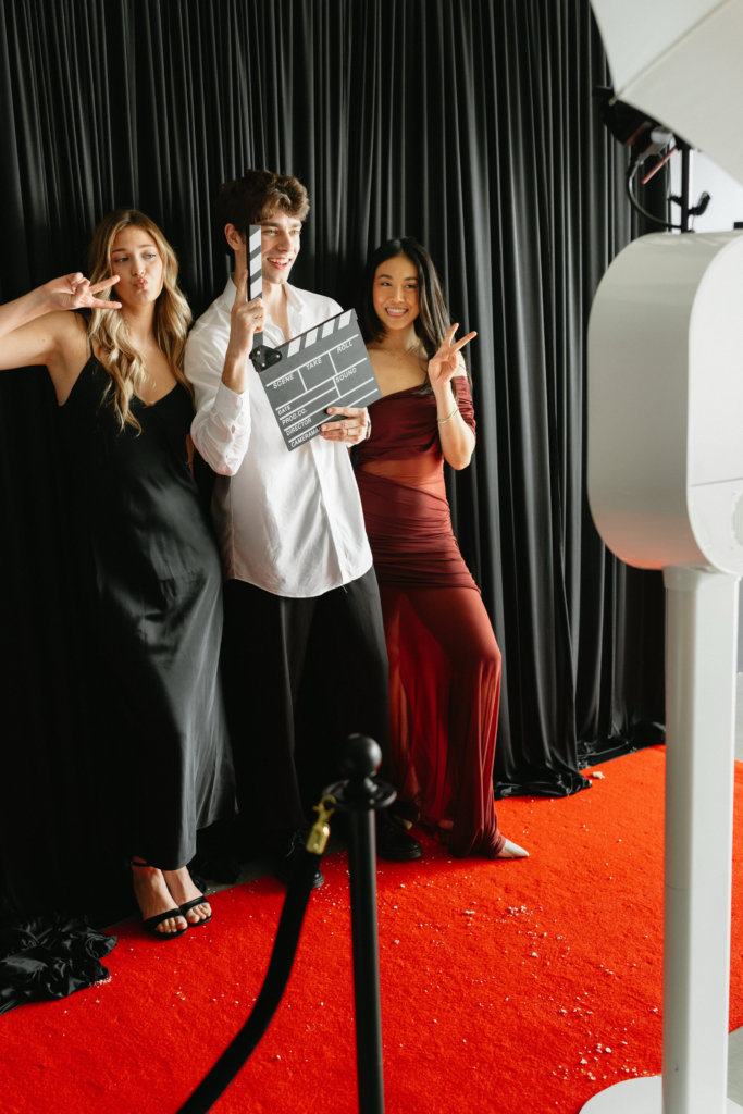 posing in Photo Booth with Photo Booth prints at event in tampa bay fl