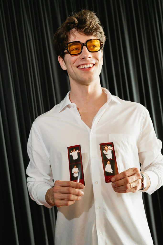 posing in Photo Booth with Photo Booth prints at event in tampa bay fl