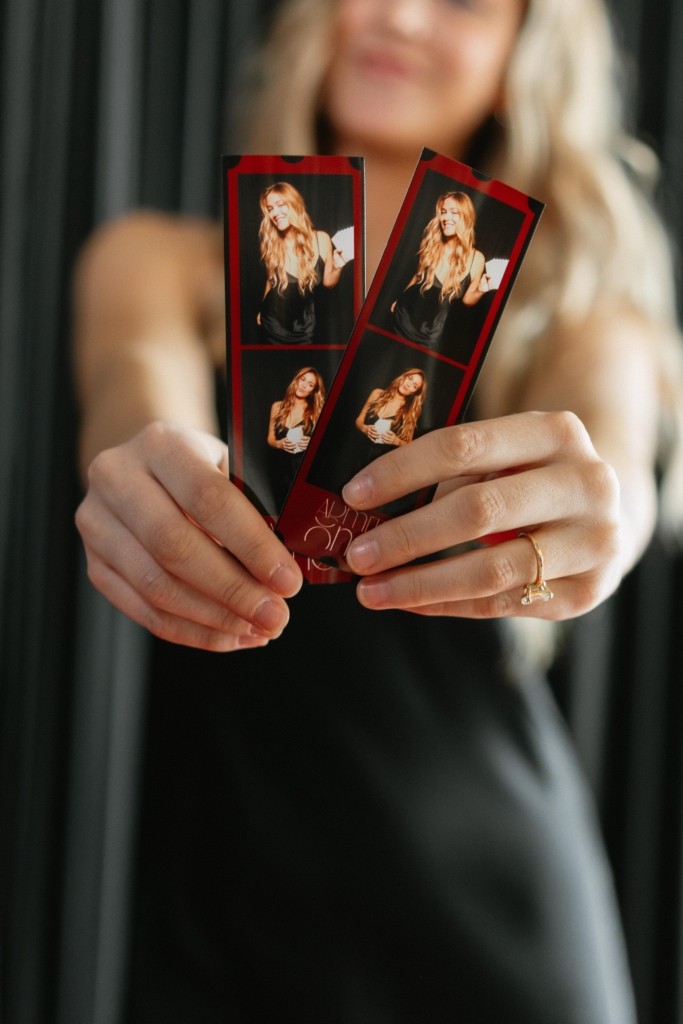 posing in Photo Booth with Photo Booth prints at event in tampa bay fl